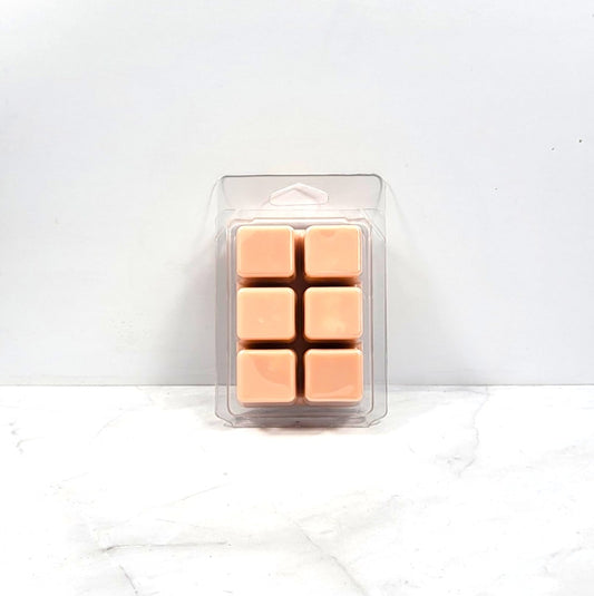 Pack of six tan-colored wax melts in a clear plastic packaging on a white background