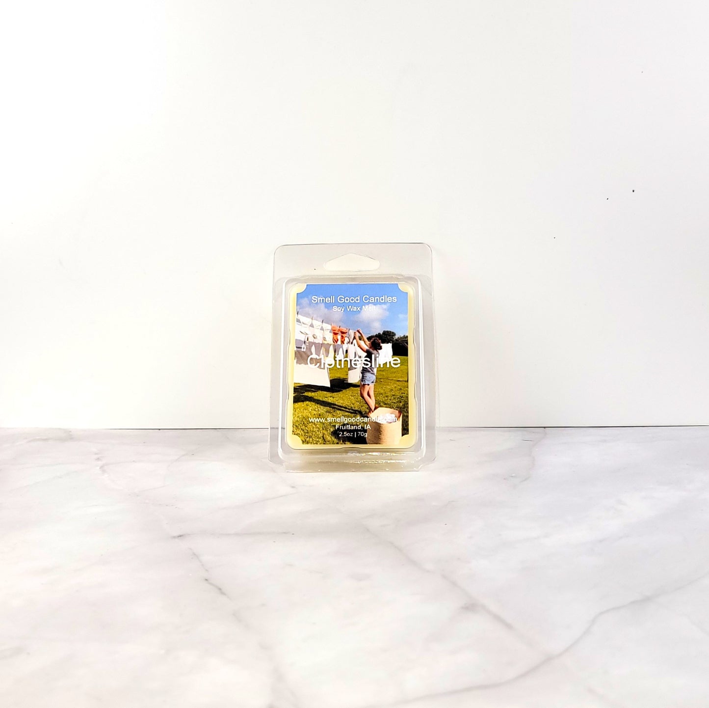 Clothesline wax melt with citrus, florals, and clean linen imagery
