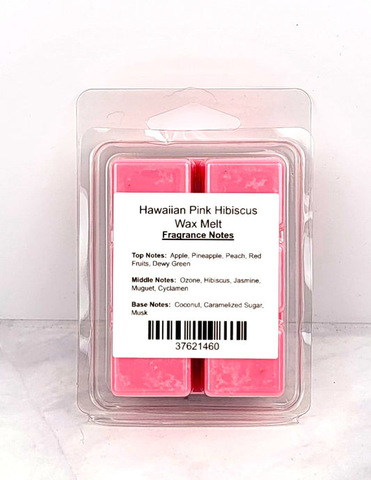 Soy wax melt cubes beside a beach towel, pineapple, and coconut