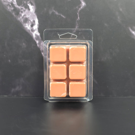 Six-pack of brown Hot Cocoa scented soy wax melts displayed on a black marble background.