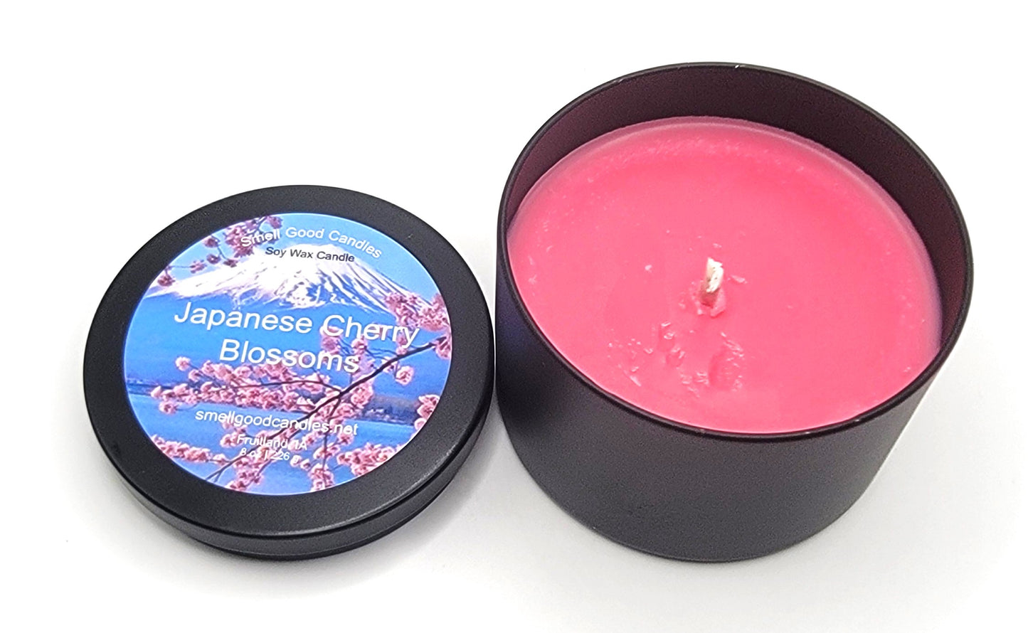 Elegant cherry blossom-scented candle in a tranquil setting.