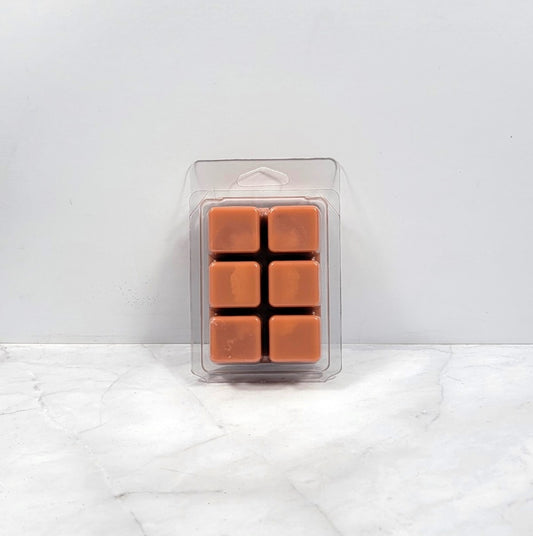 Masculine soy wax melt styled with dark oak and vanilla beans