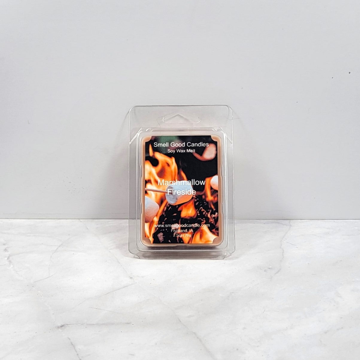 Marshmallow Fireside wax melt next to a crackling fireplace
