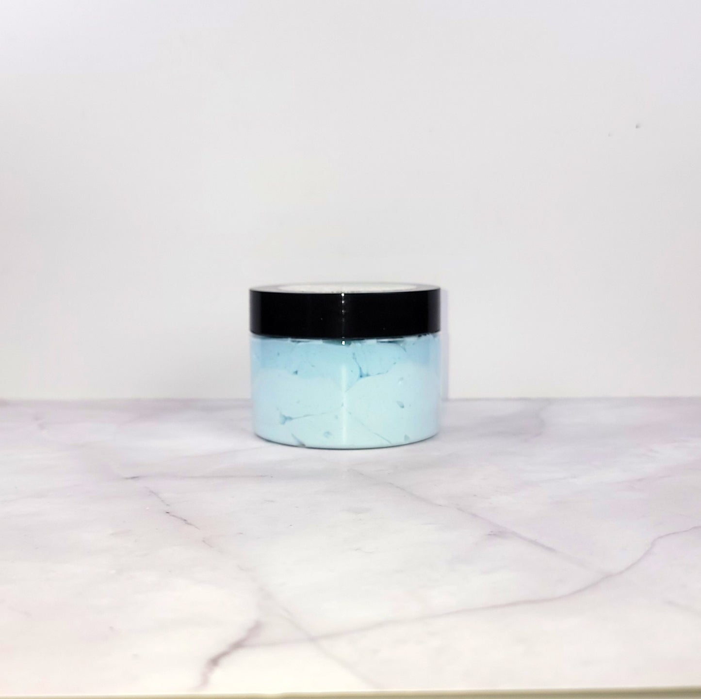 Coastal-inspired Sea Minerals Whipped Lotion with a fresh ozone top, eucalyptus heart, and freesia base for nourishing hydration and a delicate scent.