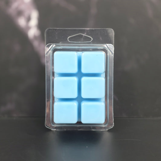 Clear plastic packaging with six blue square items on a dark background
