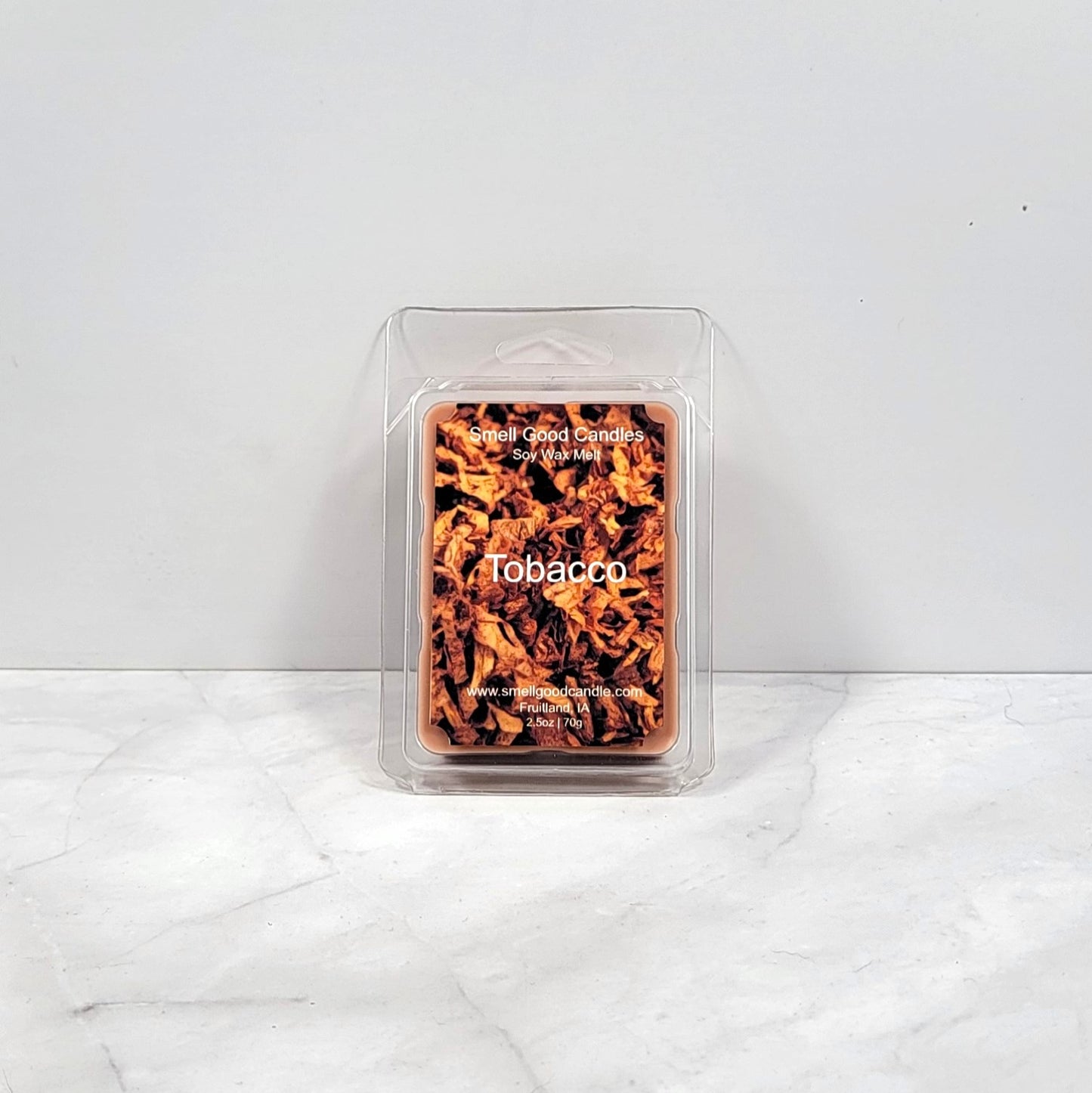 Tobacco soy wax melt with dark woods and leather backdrop