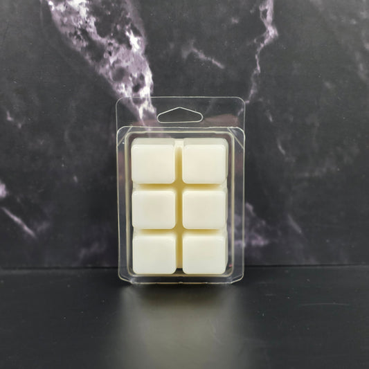 Packaged wax melts on a dark marble surface