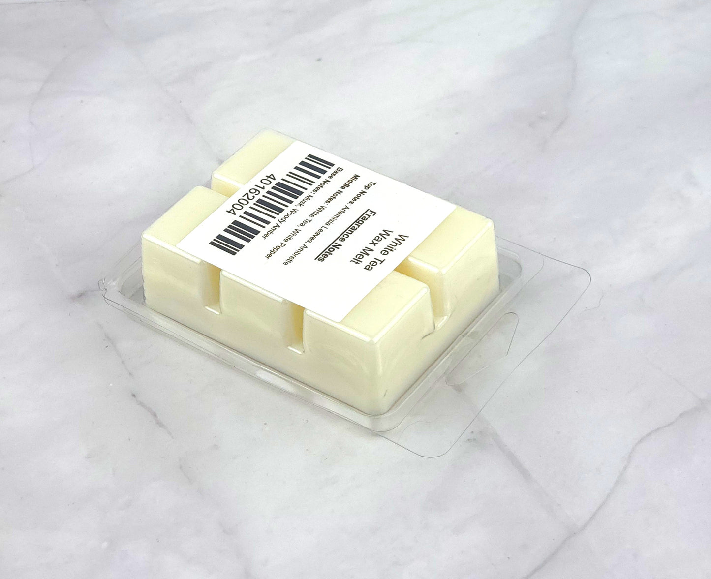 Luxurious White Tea Soy Wax Melt with herbaceous artemisia, white tea, and refined woody amber for a tranquil home ambiance.