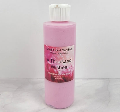 Smooth, whipped texture of A Thousand Wishes Body Lotion in a creamy swirl