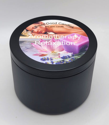 Closed matte black tin aromatherapy relaxation soy wax candle with full-color label