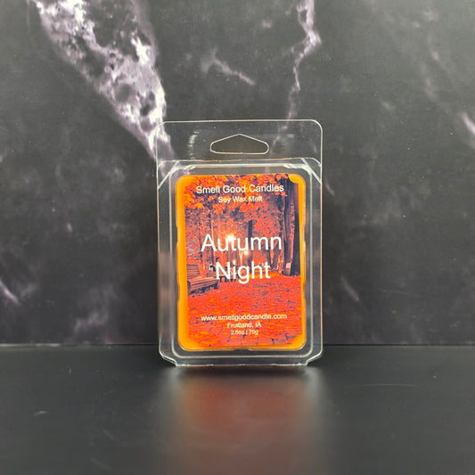 Wax melt package labeled 'Autumn Night' on a dark marble surface