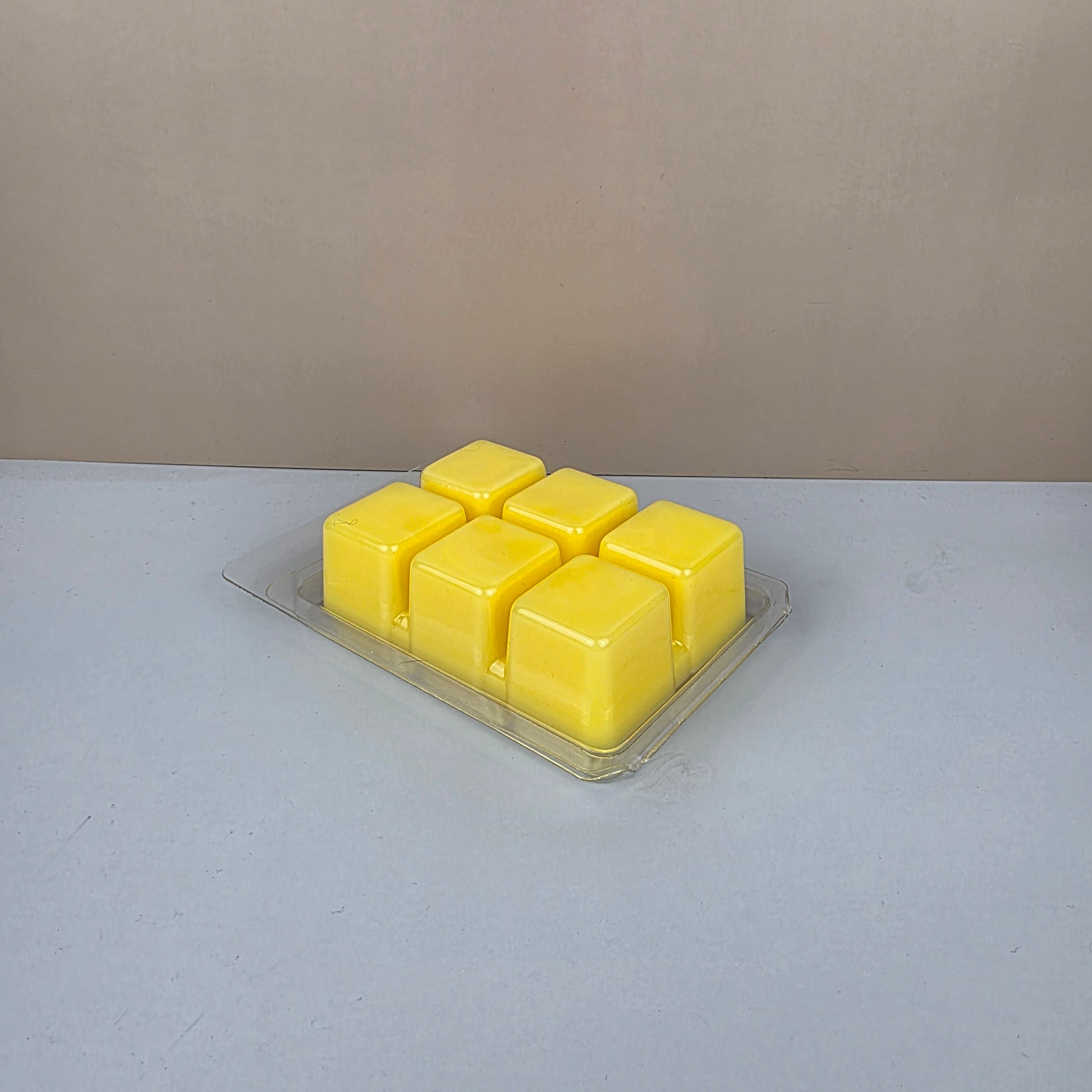 Pack of yellow wax melts on a gray surface