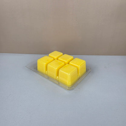 Pack of yellow wax melts on a gray surface
