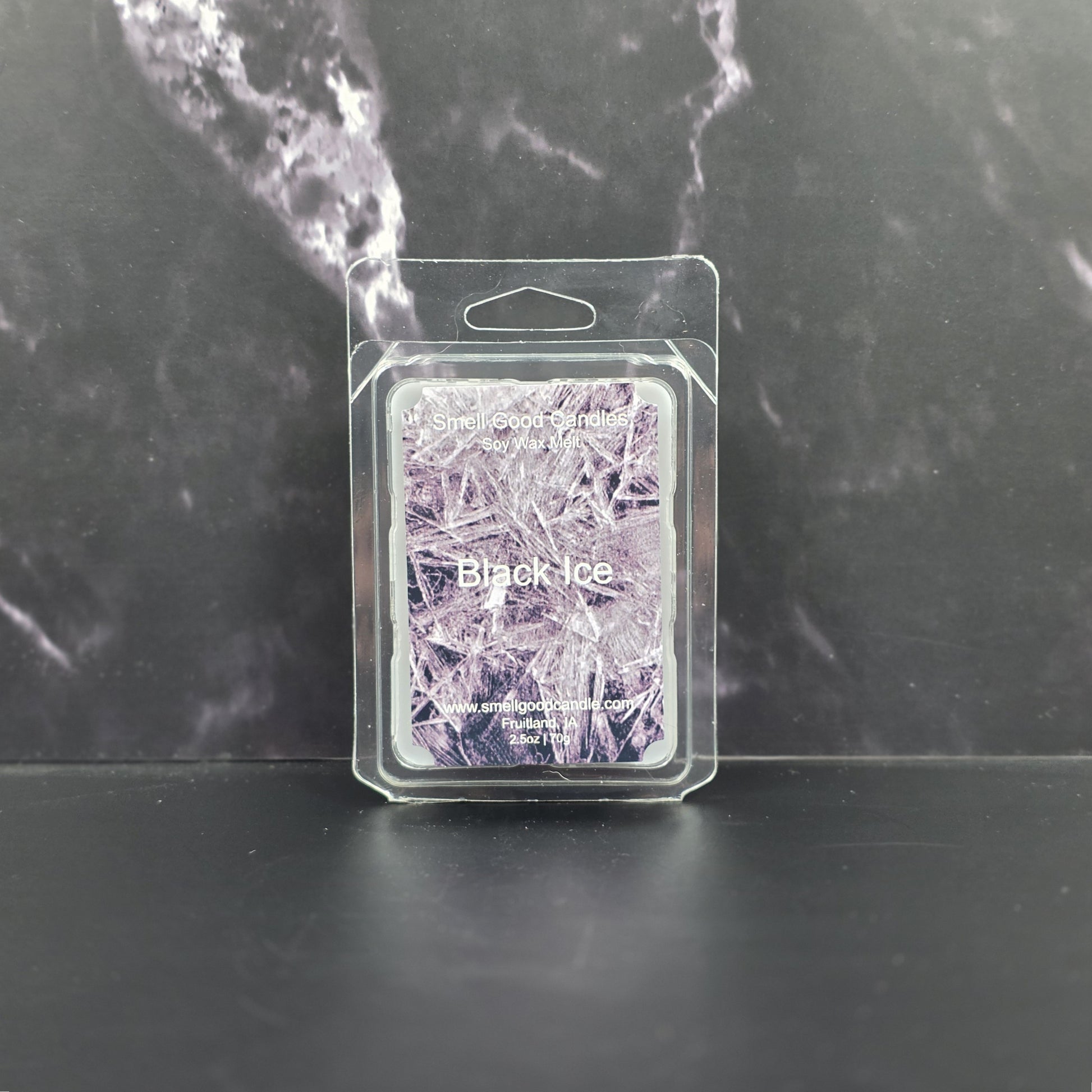 Packaged wax melt with 'Black Ice' design on a dark marble background