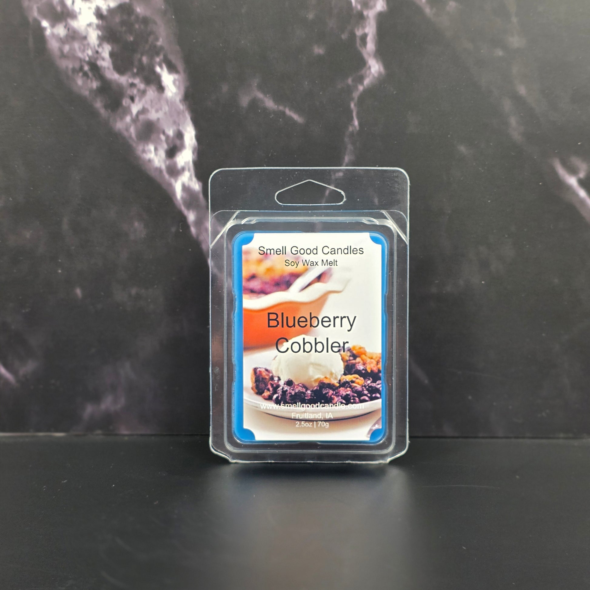 Blueberry Cobbler scented wax melt package on a dark marble surface