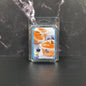 Packaged blueberry muffin wax melts on a dark surface with a marble background