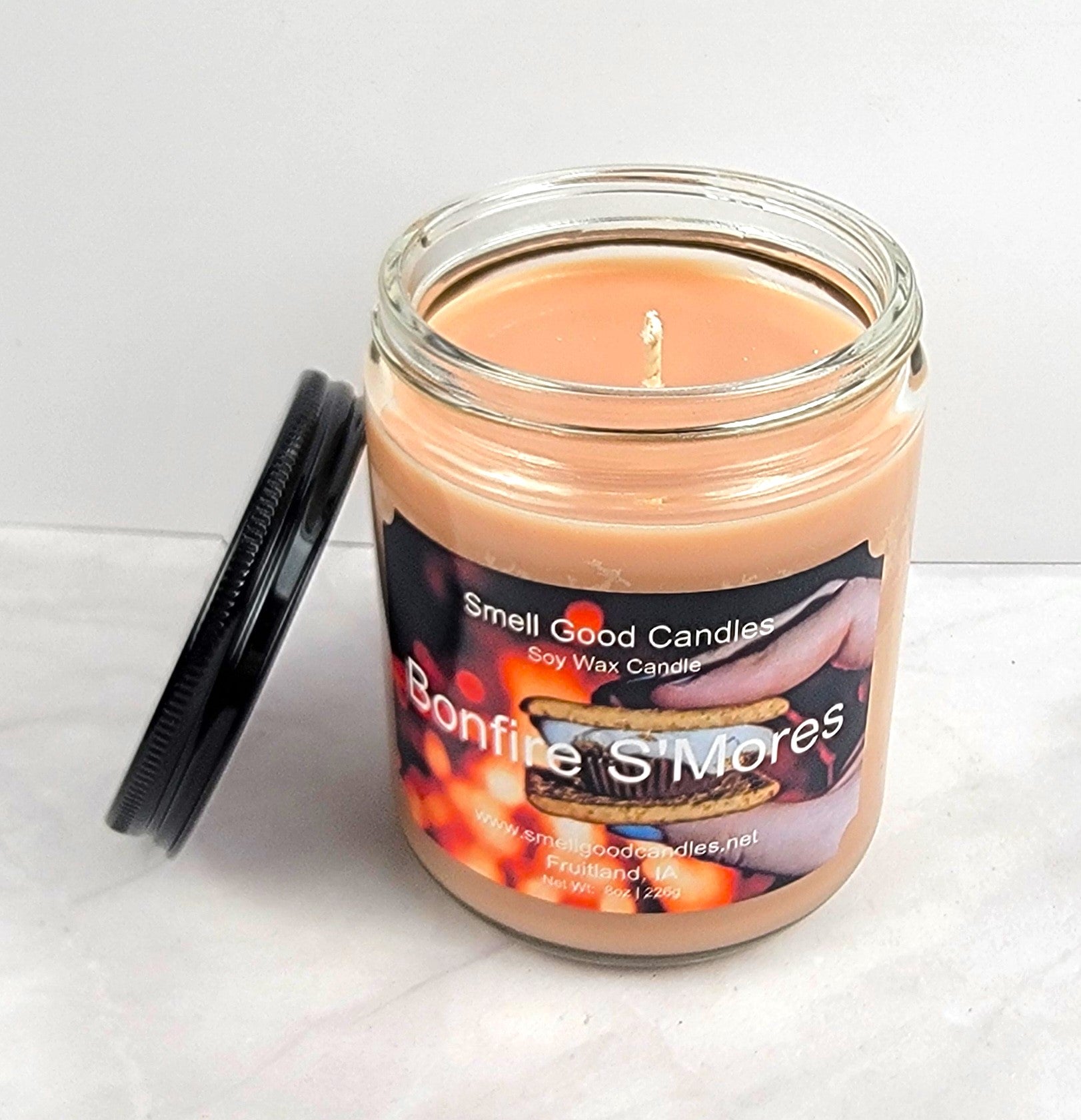 Hand-poured candle in amber jar with chocolate and firewood