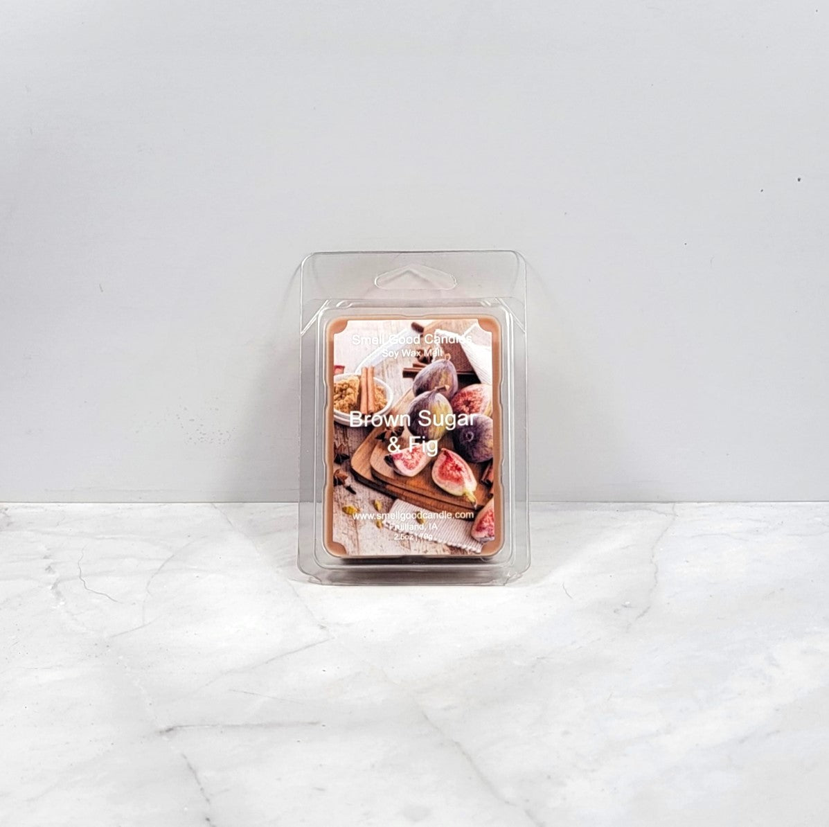 Wax melt package labeled 'Brown Sugar & Fig' on a white surface with a light gray background