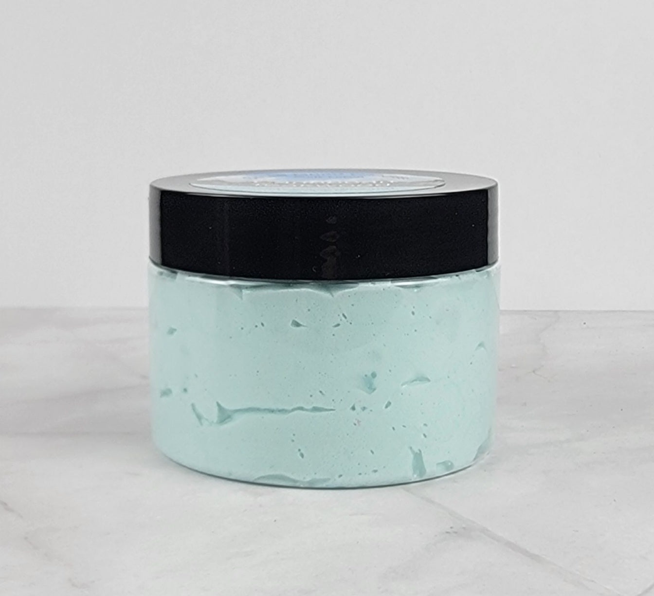 Richly moisturizing whipped body lotion with teakwood, leather, and amber scent