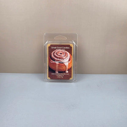 Packaged cinnamon bun wax melts on a neutral background