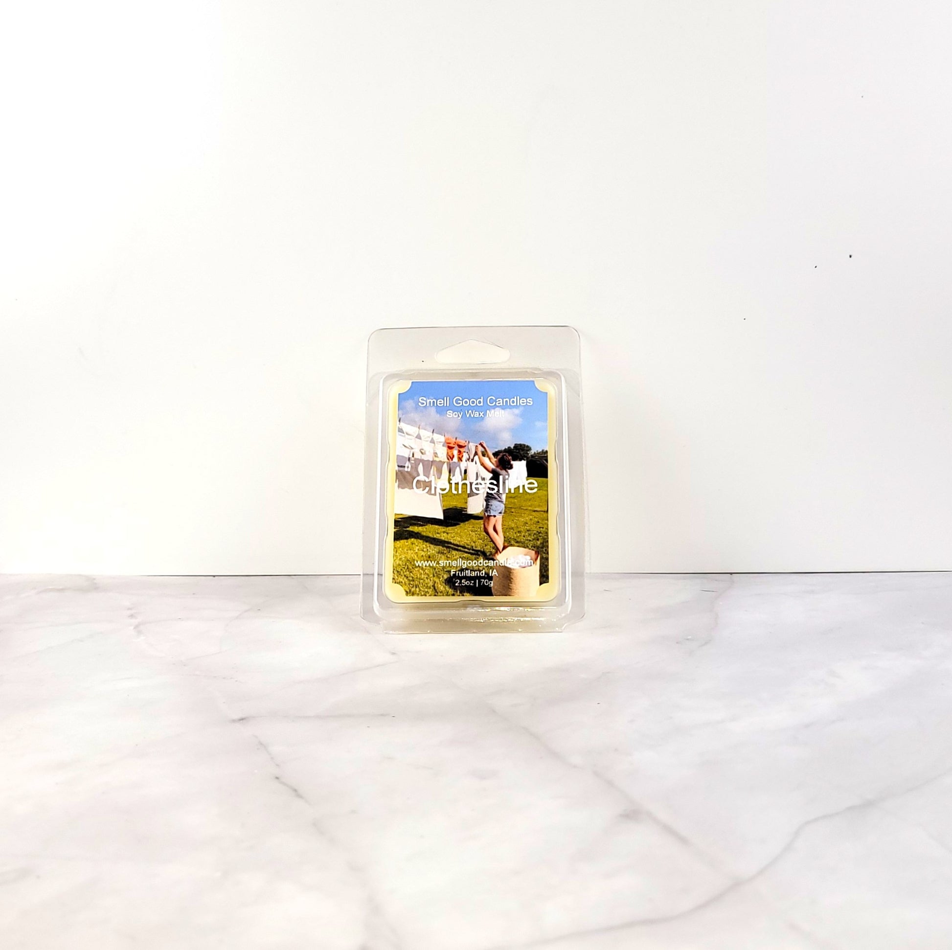 Clothesline wax melt with citrus, florals, and clean linen imagery