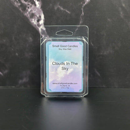 Wax melt packaging labeled 'Clouds In The Sky' on a dark marble surface