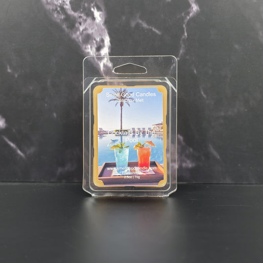 Packaged wax melt with cocktail-themed design on a dark marble background
