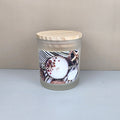 Coconut and santal soy wax candle in a white frosted jar with wood lid