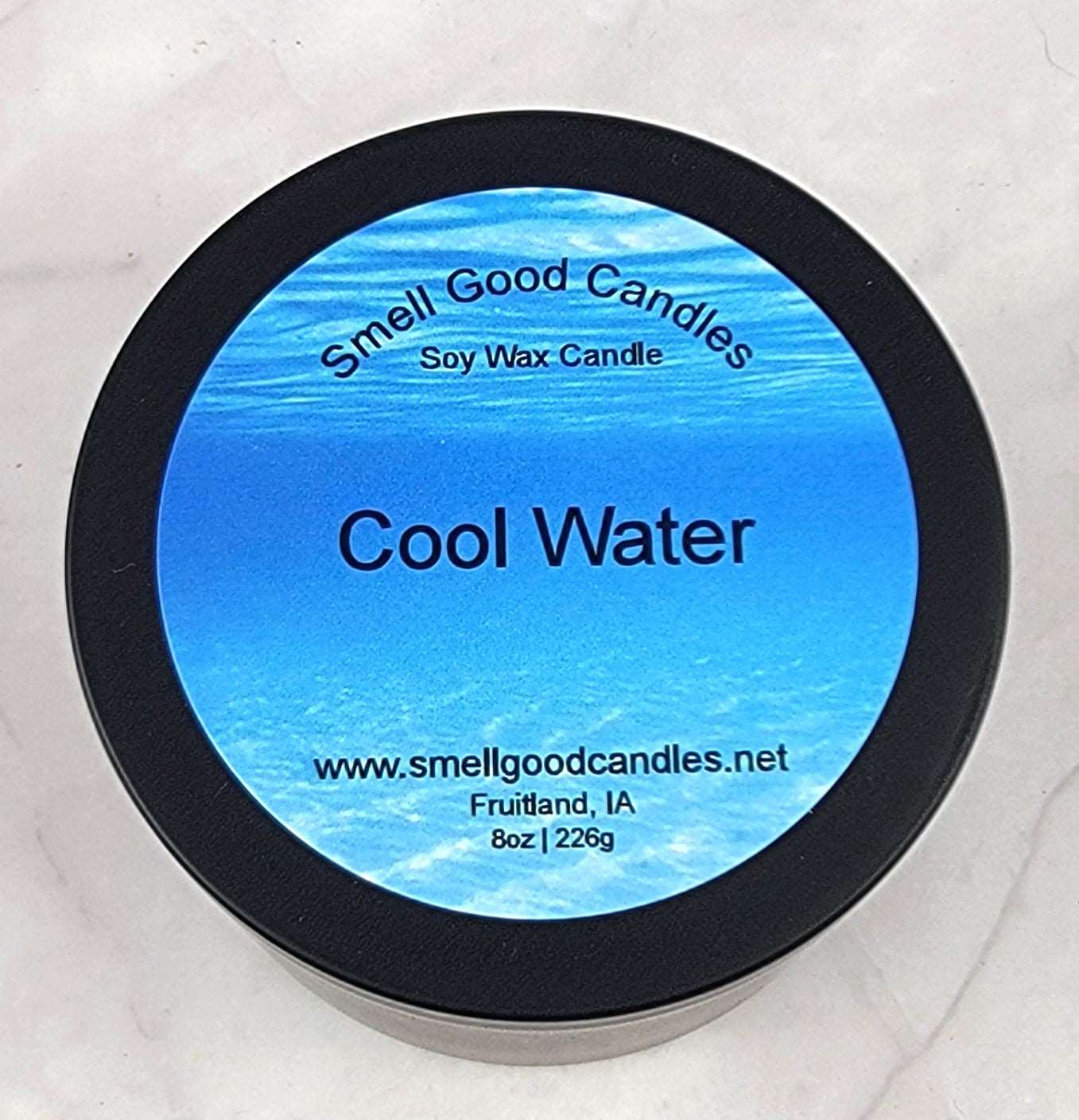 Cool Water soy wax candle - Closed matte black tin with bright blue label, 8 oz