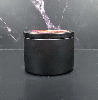 Black cylindrical container with a lid on a dark marble surface