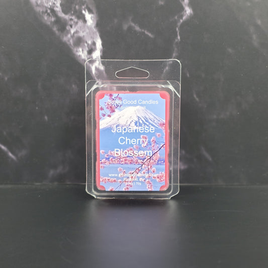 Packaged candle labeled 'Japanese Cherry Blossom' on a dark background
