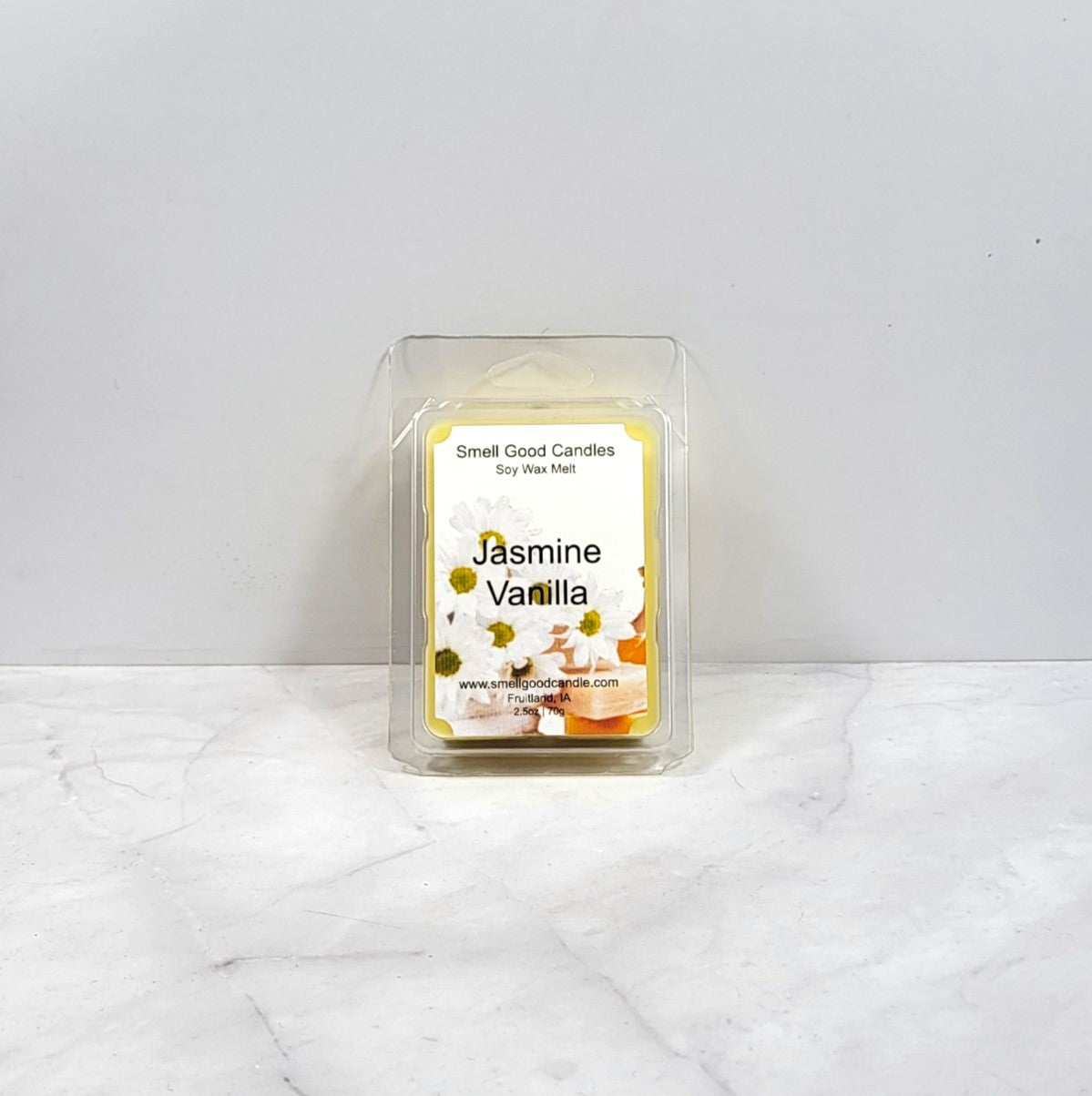 Wax melt in clear packaging with a label showing jasmine flowers and vanilla on a white background