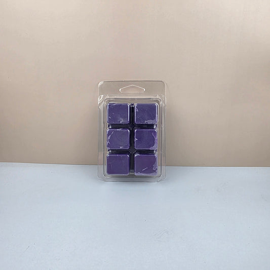 Pack of purple wax melts in a clear plastic packaging on a beige and white background