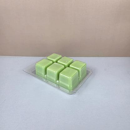 Pack of green wax melts on a white background