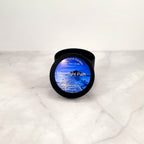 Moonlight Path 4oz soy candle with floral arrangement.