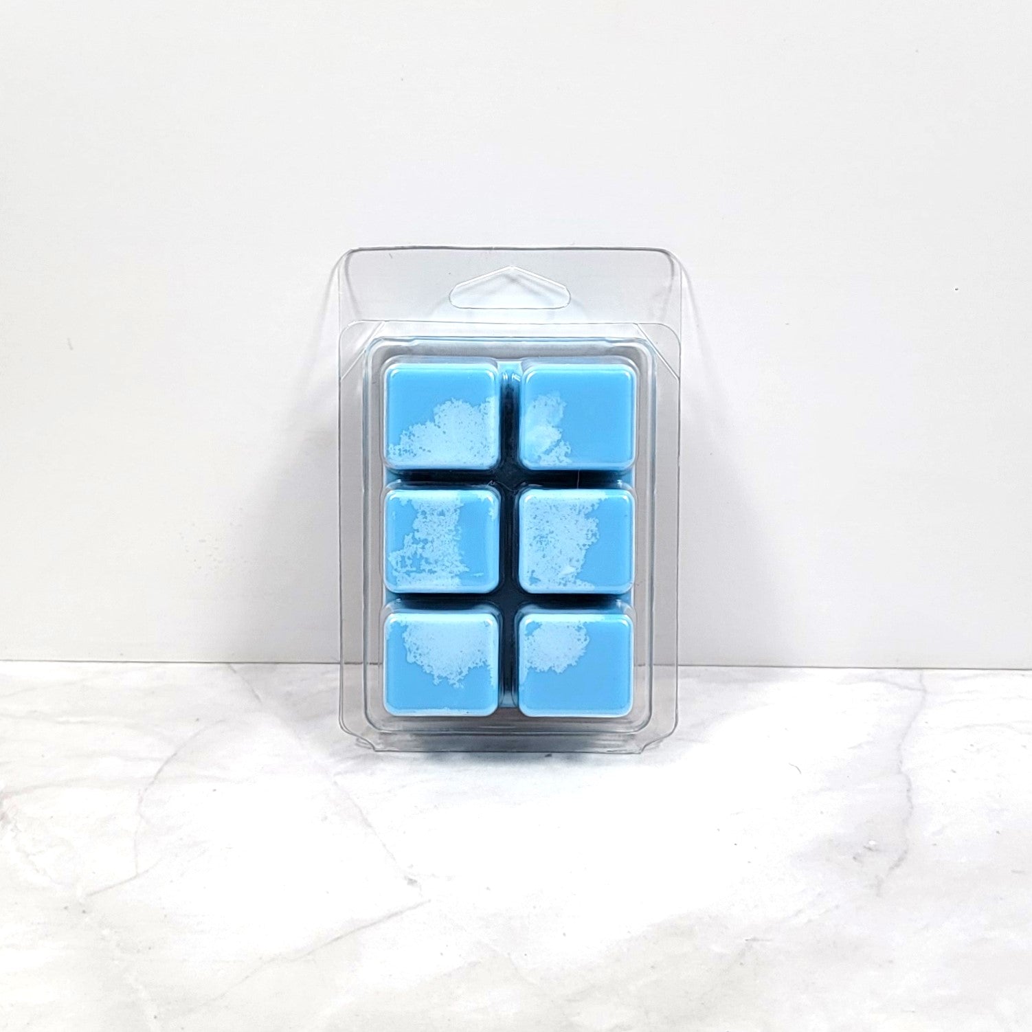 Wax melt cubes styled with coastal decor and a splash of ocean blue