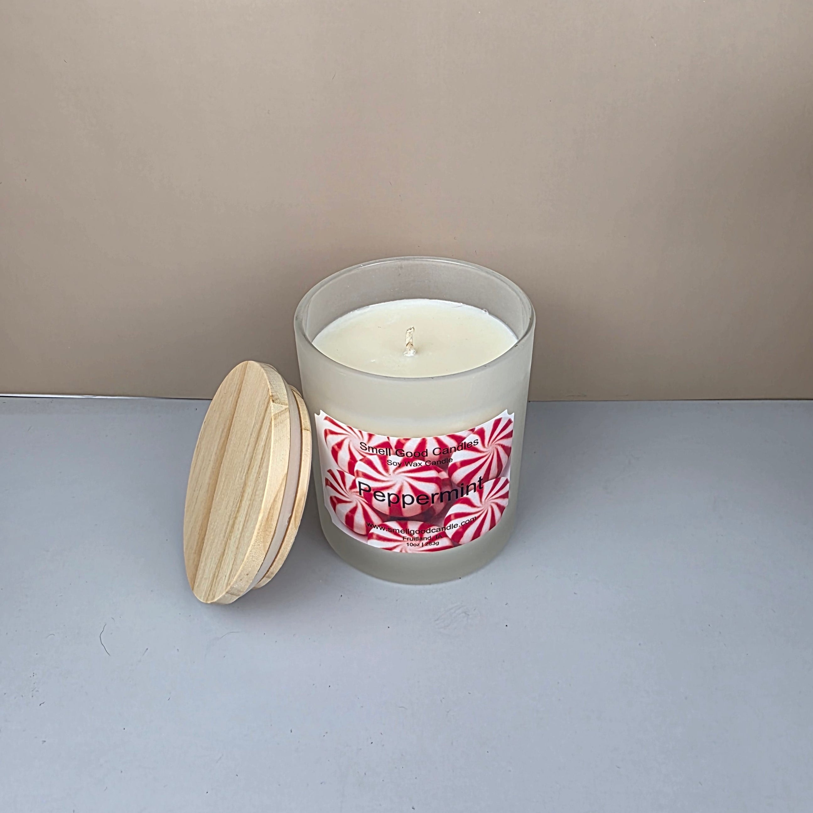 White peppermint candle in a frosted glass jar and a wooden lid