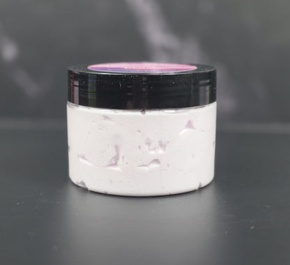 Whipped body lotion with lavender, pink sugar, and amber fragrance in a clear jar with a black lid