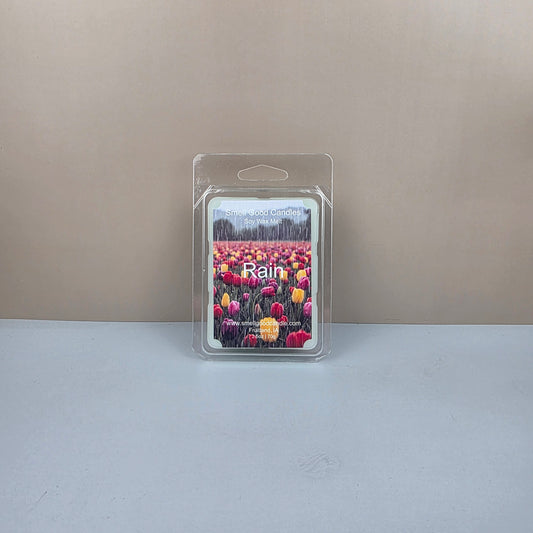 Packaged wax melt with floral design on a neutral background