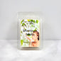 Scented wax melt packaging with a woman's face and floral design on a white background