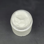Jar of white cream on a dark gray background