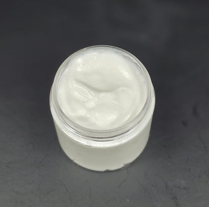 Jar of white cream on a dark gray background