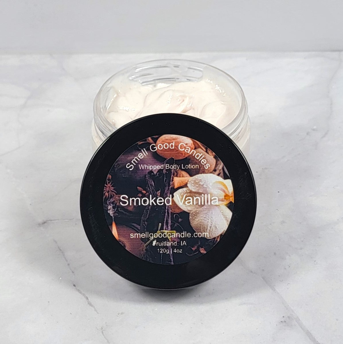 Smoked Vanilla whipped lotion in rustic wood setting