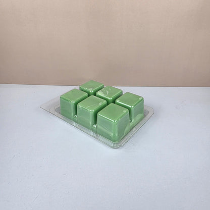 Pack of green wax melts on a white background