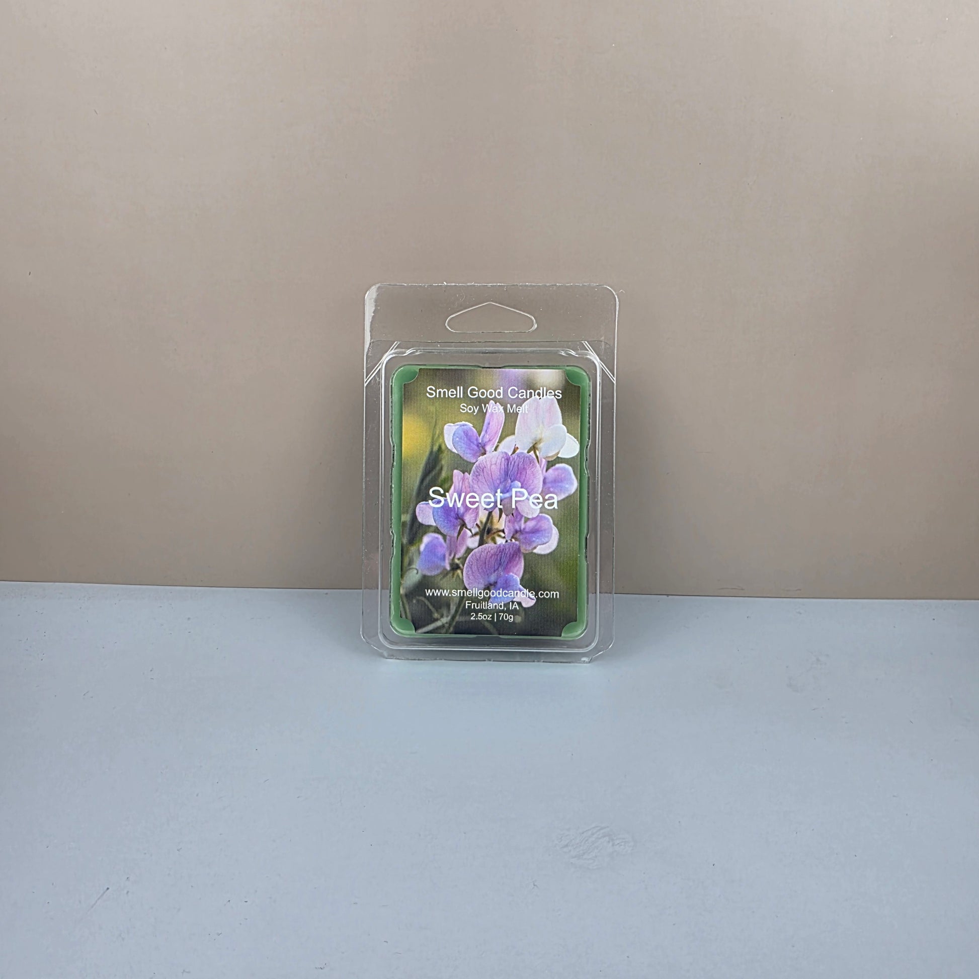 Packaged Sweet Pea wax melt on a neutral background