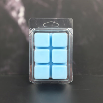 Clear plastic packaging with six blue square items on a dark background
