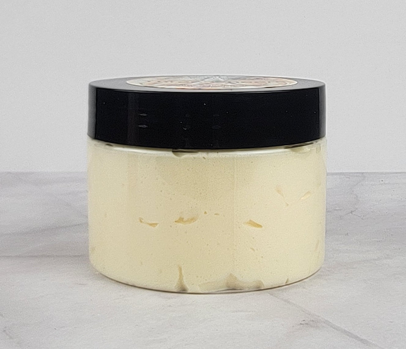 Bright citrus and amber-scented whipped body lotion for soft, glowing skin