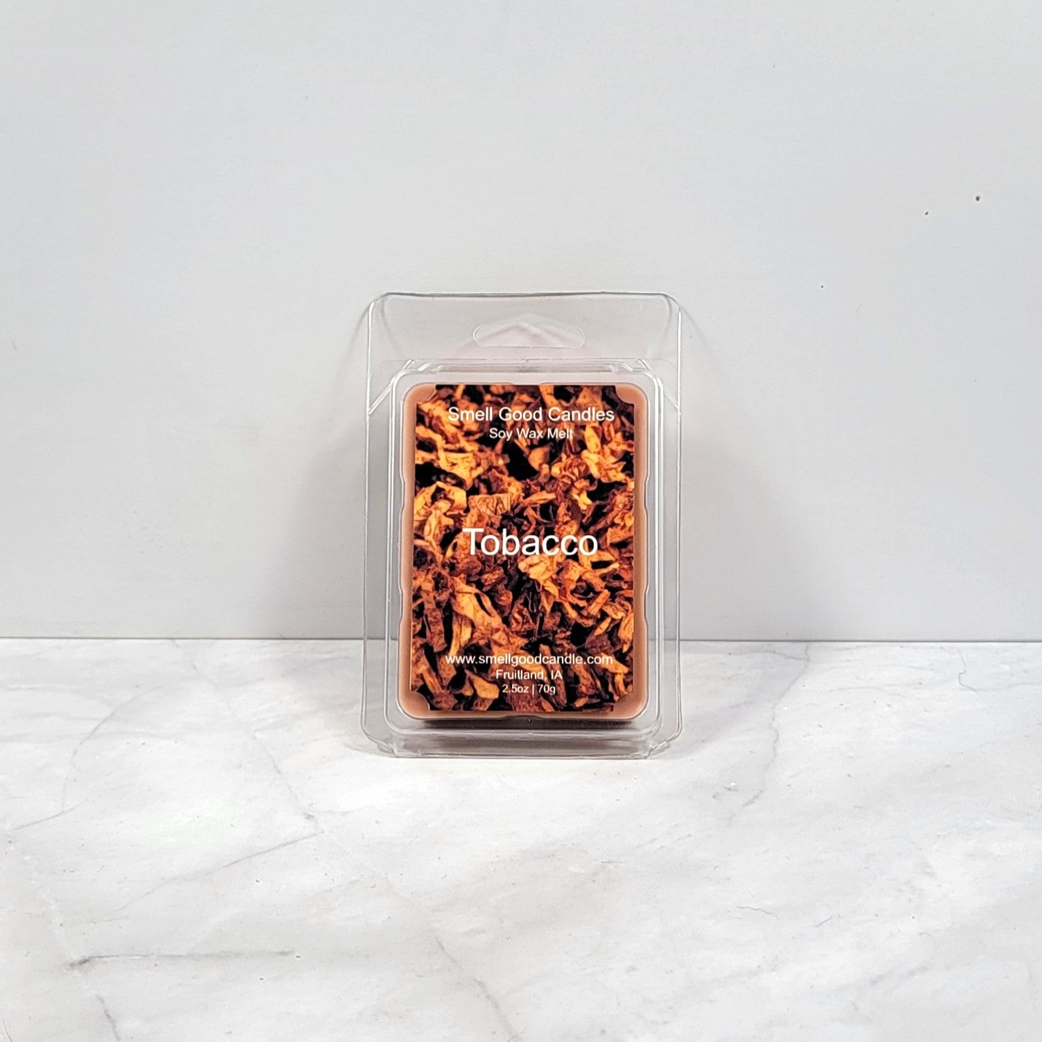 Tobacco soy wax melt with dark woods and leather backdrop