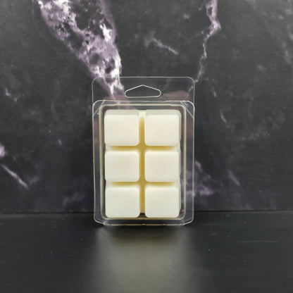 Packaged wax melts on a dark marble surface