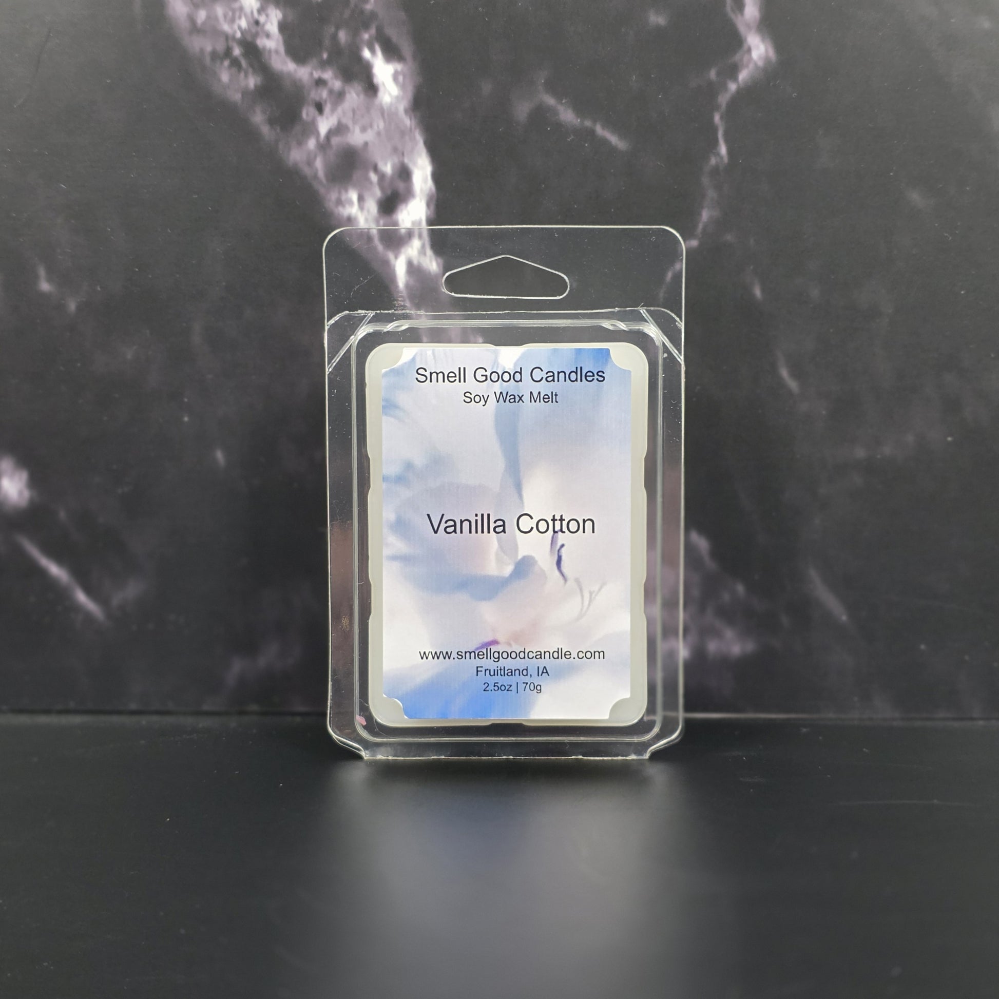 Packaged vanilla cotton soy wax melt with 'Smell Good Candles' label on a dark marble background